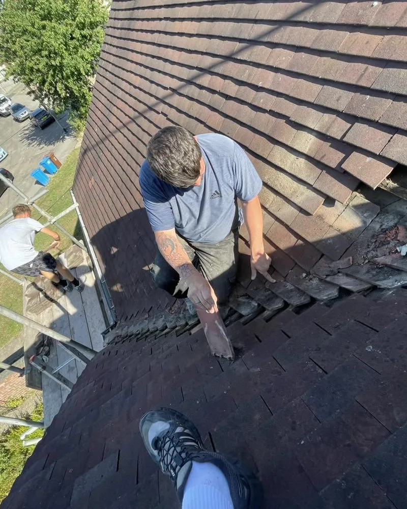 Roofer fixing slates at a valley