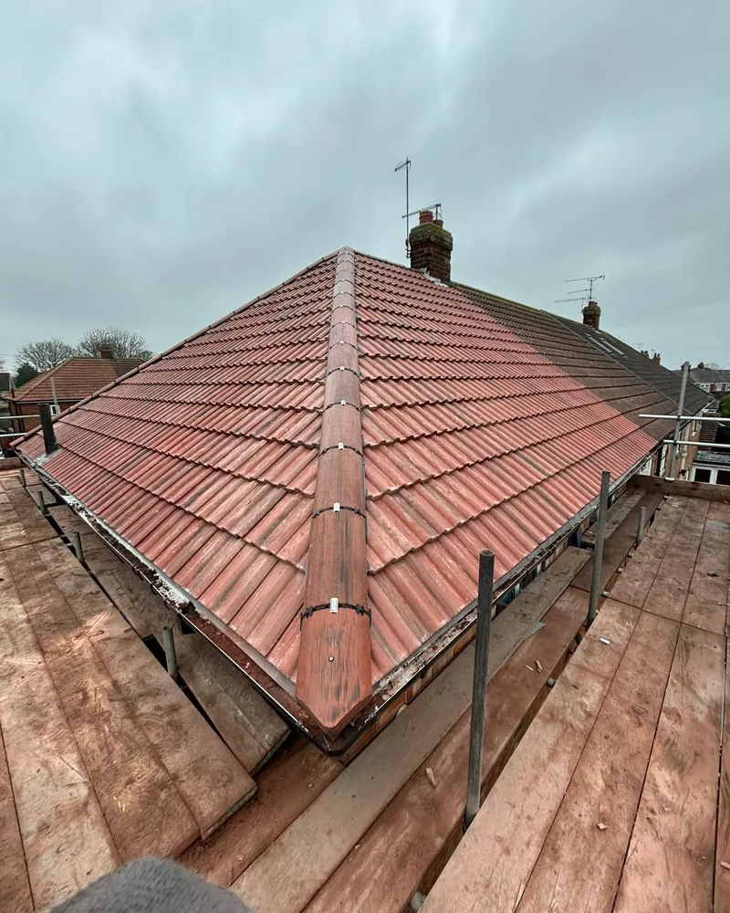 Red tiled hipped roof after re-roofing